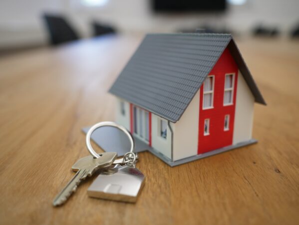 A miniature home and a set of keys