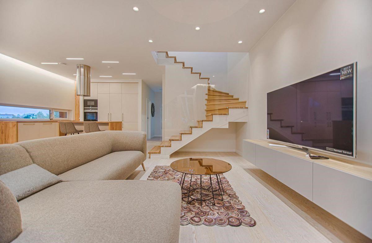 A beautiful living room with a grey smart TV and white walls