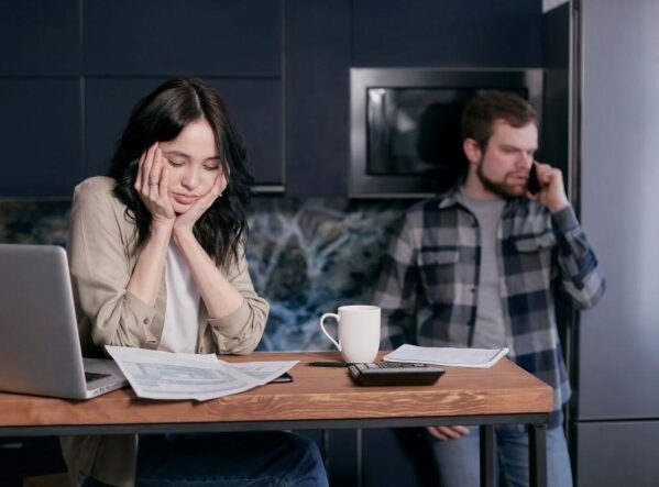 A woman looking at her electricity bills on the table